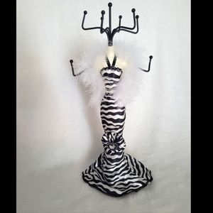 Jewelry stand/holder. 9 prongs. Zebra dress manican with white fluffy boa.